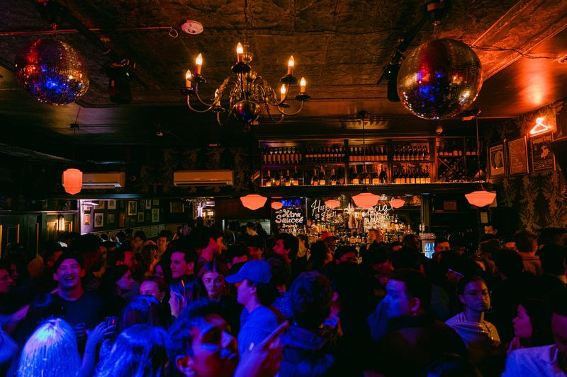 A full house in the lobby bar under chandeliers and disco balls
