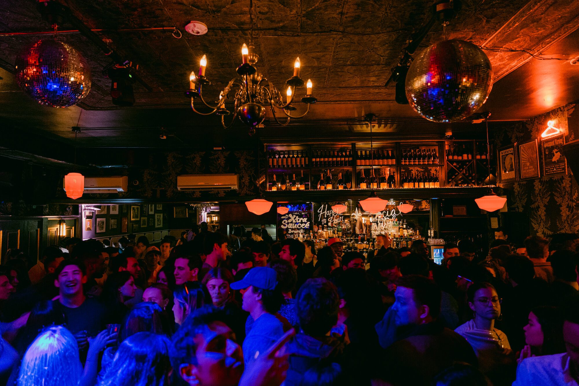 A full house in the lobby bar under chandeliers and disco balls