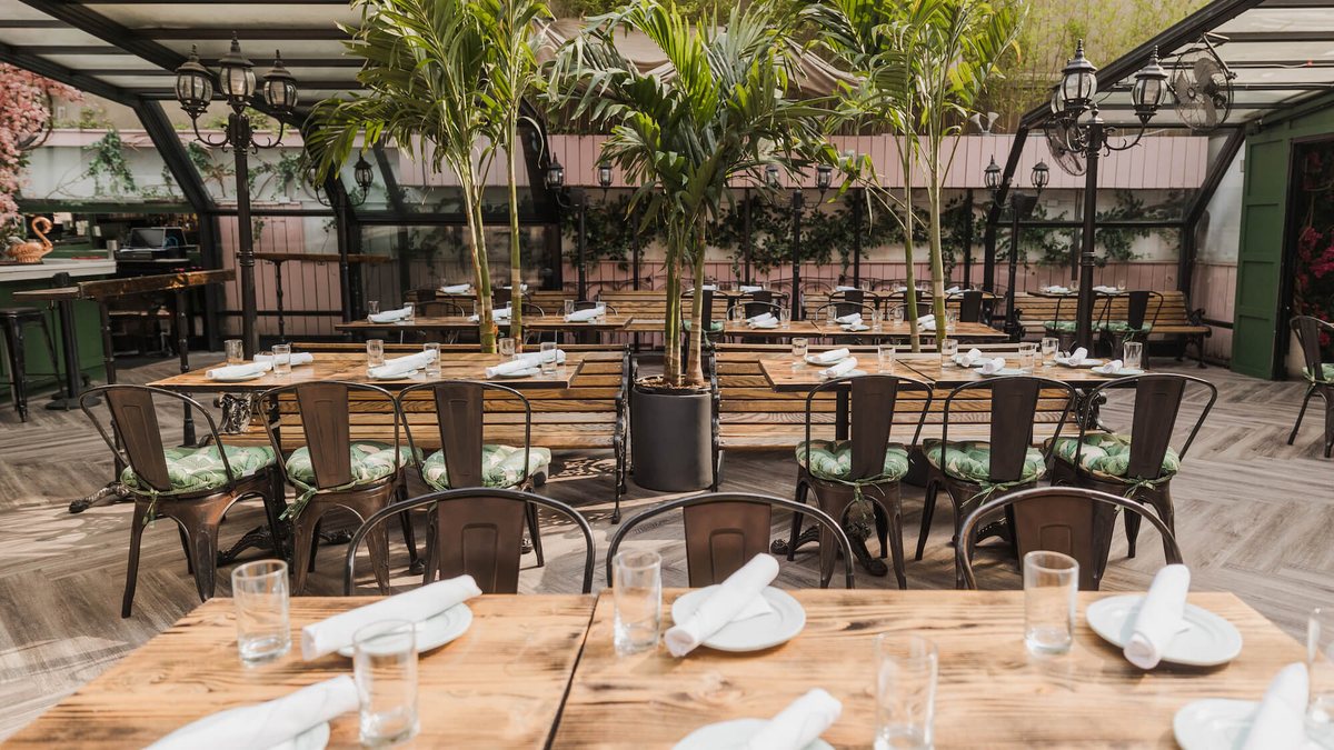 Rooftop tables and palms under the glass ceiling