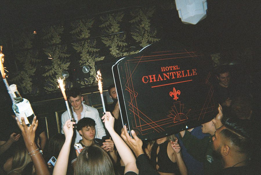 Sparklers and the Hotel Chantelle sign held over the crowd